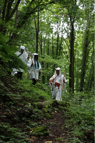 Yamabushi monk hiking through a forest